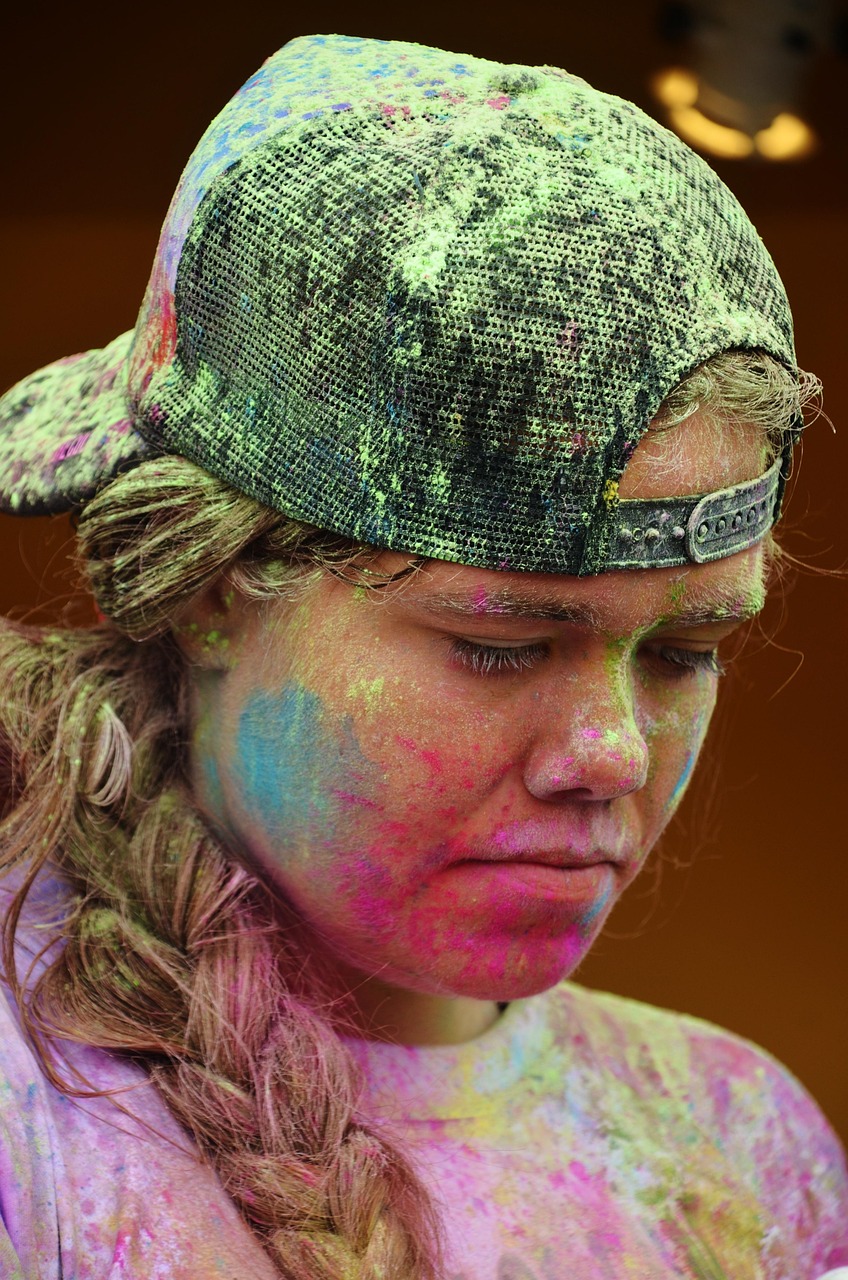 Participants covered in vibrant colour powder at a colour run festival event