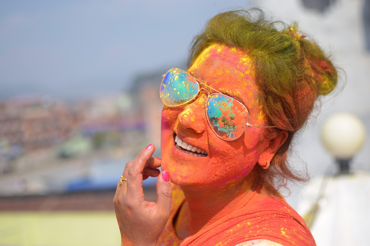Woman celebrating Holi festival with vibrant colour powder in Nepal — traditional festival colour culture